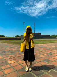 Full length of boy standing on footpath