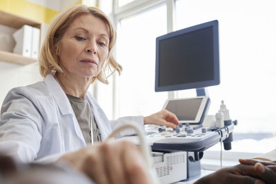 Doctor doing ultrasound of patient in clinic