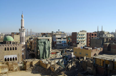 High angle view of buildings against clear blue sky