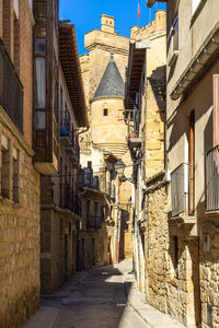 A street in olite with the royal palace of olite in the background, navarre, spain,