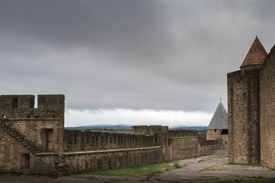 View of old building against cloudy sky