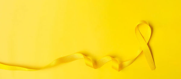 Yellow ribbon on yellow background