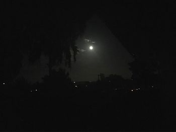 Silhouette landscape against sky at night