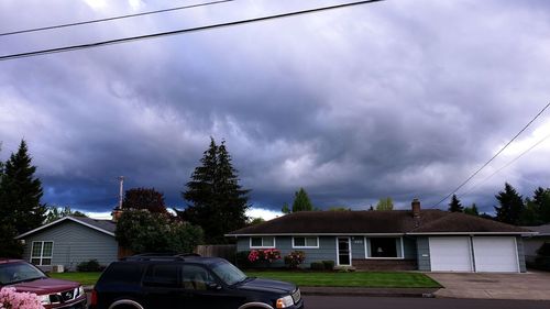 Buildings against cloudy sky