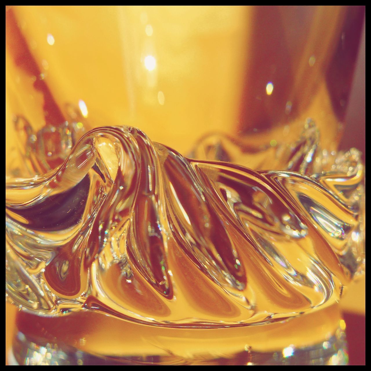 CLOSE-UP OF DRINK ON GLASS TABLE
