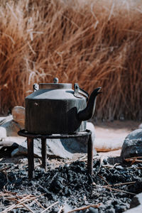 Kettle over charcoal during camping trip