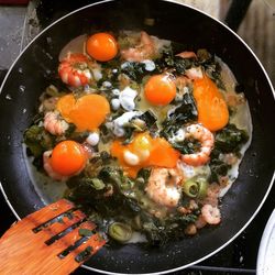 High angle view of food cooking in frying pan on stove