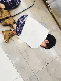 High angle view of man lying on floor