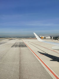 Airplane on runway against sky