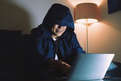 Young man using mobile phone at home
