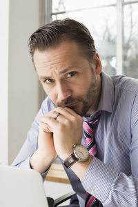 Portrait of confident mid adult businessman in office