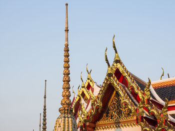 Low angle view of statue against temple against clear sky