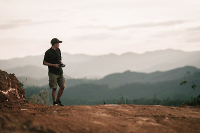 Rear view of man standing on mountain