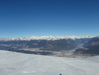 Scenic view of mountains against clear blue sky