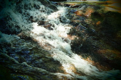 Close-up of waterfall along river