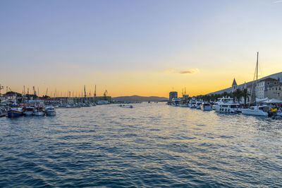 Sailboats in marina at sunset