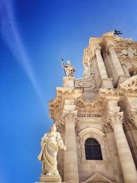 Statues at cathedral of syracuse against sky