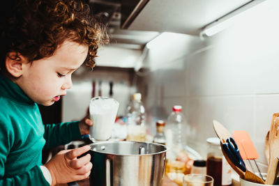 Cute girl cooking at kitchen