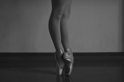 Low section of ballet dancer standing on floor