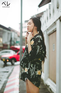 Woman standing on street in city