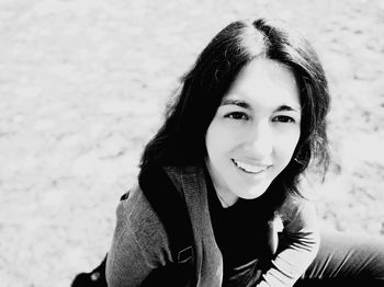 Portrait of smiling woman sitting outdoors