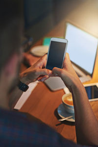 Midsection of woman using digital tablet on table