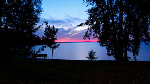 Scenic view of lake against sky during sunset