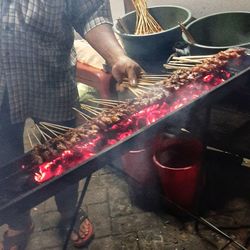 Midsection of man preparing food in kitchen