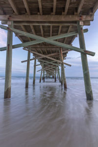 Silhouette of pier on sea against sky