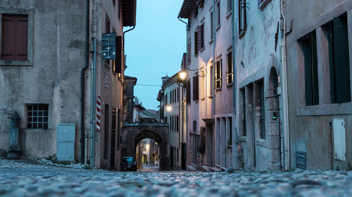 Street amidst buildings in city during winter