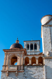 Low angle view of old building against clear blue sky