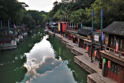 Boats moored in canal against sky