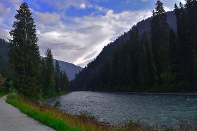 Scenic view of river amidst mountains against sky