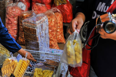 Midsection of man working at market stall