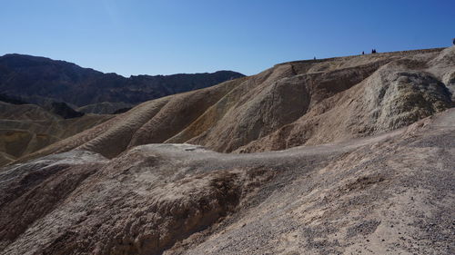 Scenic view of desert against clear blue sky