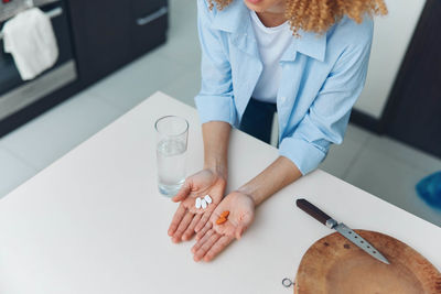 Midsection of female doctor examining patient