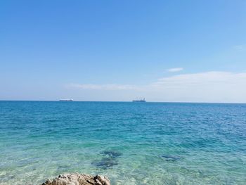 Scenic view of sea against blue sky