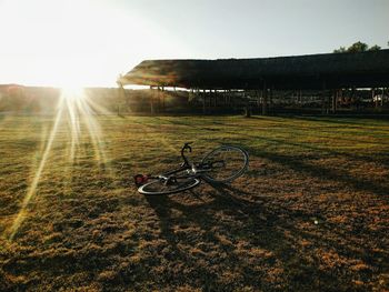 View of bicycle on field against clear sky