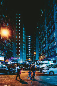 City street and illuminated buildings at night