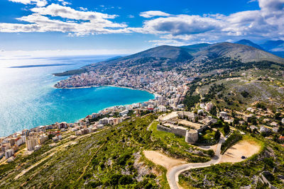 High angle view of townscape by sea against sky