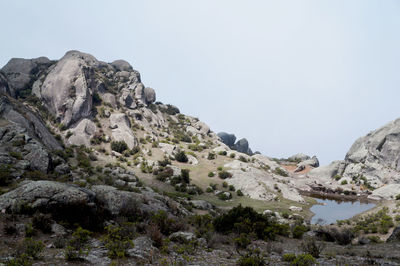 Scenic view of pond amidst rock formation