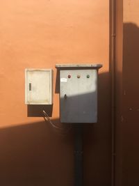 Fuse box on orange wall