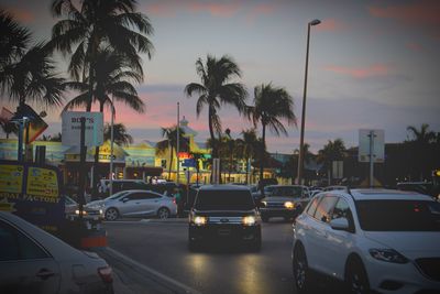Traffic on road at sunset