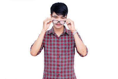 Mid adult man standing against white background