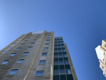 Low angle view of building against clear blue sky