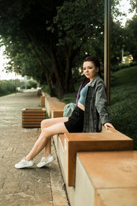 Portrait of young woman working at park