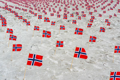 High angle view of red flags on sand at beach