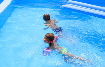 High angle view of kids swimming in pool