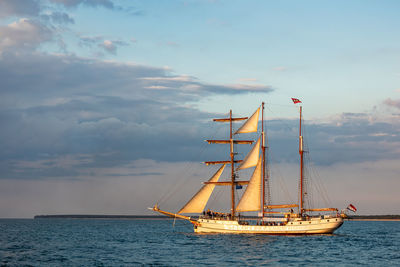 Sailboat sailing on sea against sky