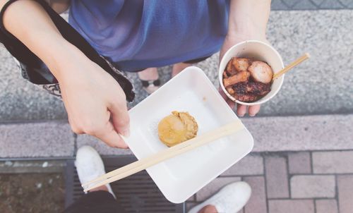 Cropped image of woman holding food